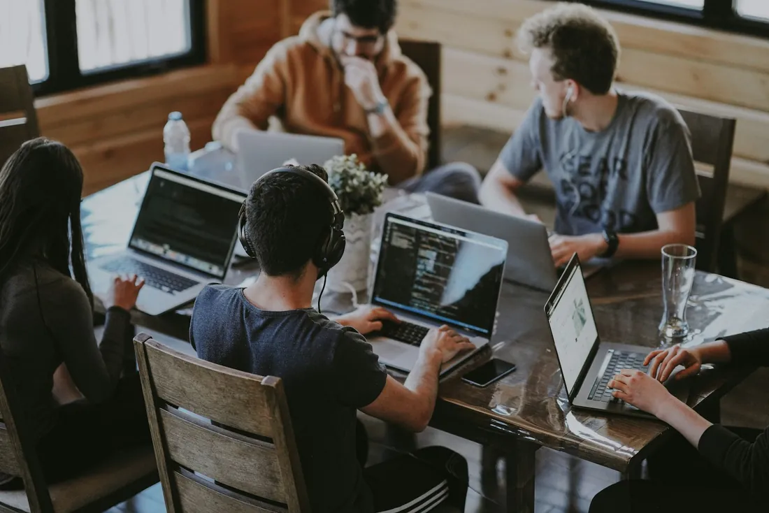 A team working together around laptops